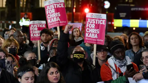 PA Media People holding placards outside the court suggesting justice had not been done