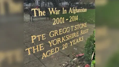 David Rimmington/BBC A war memorial in Hornsea, East Yorkshire. On it, written in gold lettering, are the words: The war in Afghanistan 2001 - 2014. Pte Gregg T Stone, The Yorkshire Regt (short for regiment), Aged 20 years.