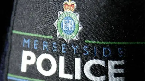 PA Media A Merseyside Police badge sewn into a seat cover