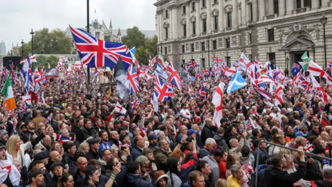Reuters Thousands of demonstrators holding flags in Whitehall