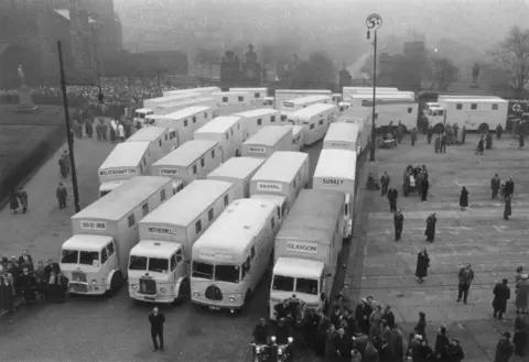 Getty Images Mobile TB screening units from across the UK parked in front of Glasgow Cathedral