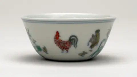 PA Media A white ceramic Doucai 'chicken cup' which is imprinted with images of a cockerel and hens
