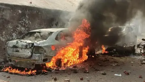 Zaki Rehman A car set on fire during protests that broke out in Sambhal on Sunday