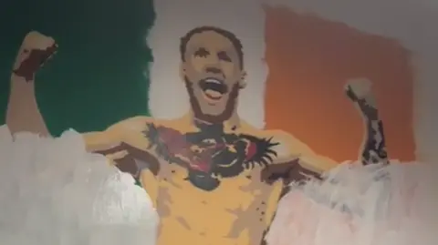 Gary Scully White paint on a mural of Conor McGregor