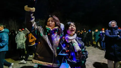 Getty Images People gather to protest against South Korean president Yoon Suk Yeol in the capital Seoul, as lawmakers vote on impeachment