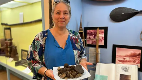 BBC/Lindle Markwell Jean Mason showing the polymetallic nodules in her museum