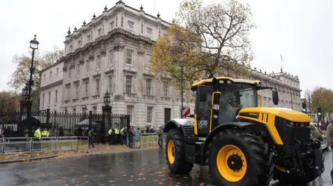 PA Media A tractor outside Downing Street as farmers gather to protest in central London over the changes to inheritance tax