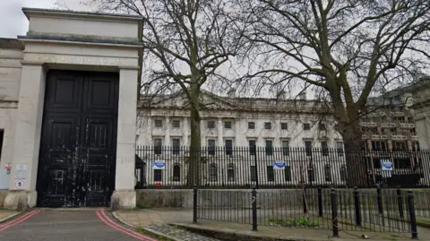 Google Royal Mint Court exterior with two trees and black railing either side of a main entrance with a black door beneath the words 'Royal Mint Court'