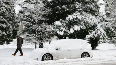 Reuters An car covered in snow in Buxton