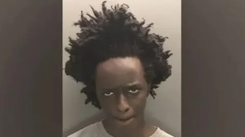 Merseyside Police Axel Rudakubana gurns at the camera in a police mugshot