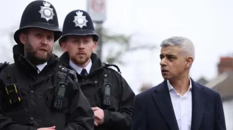 Getty Images Sir Sadiq Khan with Met police officers