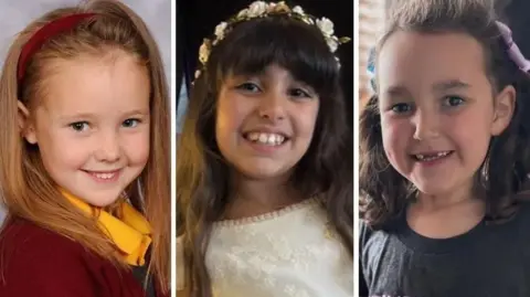 Merseyside Police A composite image of Elsie in her red and yellow school uniform, Alice in her white communion dress and Bebe in a black t-shirt and with colourful bows in her hair. All are smiling.