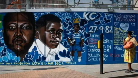 PA Media Mural of Kevin Clarke at various ages against a blue background
