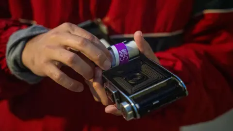 Fritz Pinnow Fabriccio Díaz is loading film into a camera that was made in the 1930s, which he was allowed to borrow from a camera store and try out.