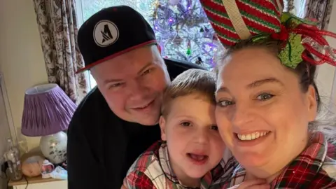 Family photo Selfie of Leo and his parents - he is wearing the same pyjamas as his mum and they are all smiling