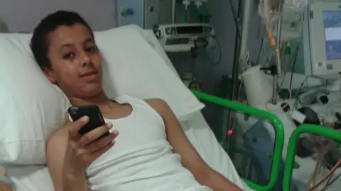 Family handout Joshua in a hospital bed