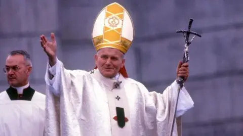 Late Pope John Paul II waving to people during a visit to Ireland in 1979