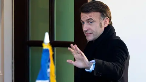 EPA Macron waves a hand as he enters the White House