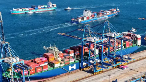 Getty Images Container ships enter and exit the port of Qingdao, Shandong province, China, 3 February, 2025.