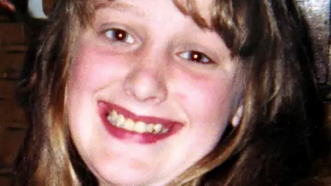 Handout Charlene Downes, who has light brown hair, smiles at the camera with her head tilted to her left.