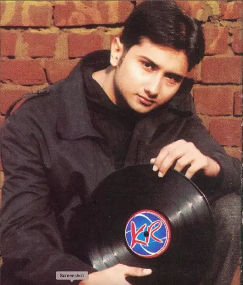 Instagram/Yo Yo Honey Singh picture of Yo Yo Honey Singh from 2003 wearing a black jacket and black sweater is holding a disc