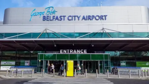Getty Images The front entrance of George Best Belfast City Airport in a sunny day.