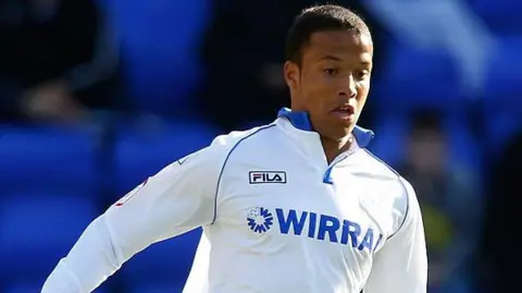 Getty Images Joe Thompson, in a white Tranmere football kit, pictured mid game