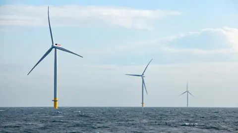 EPA/Orsted Three offshore wind turbines in the North Sea. The sky is partly cloudy.