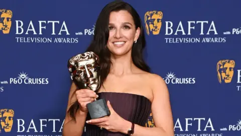 Getty Images Marisa Abela, winner of the Leading Actress Award for 'Industry', poses in the winners room at the 2025 BAFTA Television Awards With P&O Cruises at The Royal Festival Hall on May 11, 2025 in London, England.
