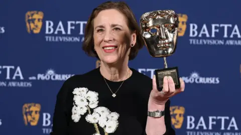 Getty Images Kirsty Wark poses with the Fellowship Award inside the Winners Room at the 2025 BAFTA Television Awards with P&O Cruises at The Royal Festival Hall on May 11, 2025 in London, England