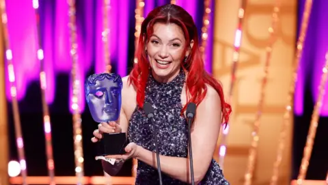 Getty Images Dianne Buswell accepts the P&O Cruises Memorable Moment Award for 'Strictly Come Dancing' onstage during the 2025 BAFTA Television Awards with P&O Cruises Ceremony at The Royal Festival Hall on May 11, 2025 in London, England.