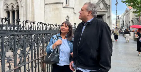 Brendan and Marion Chesterton outside the Royal Courts of Justice, hand in hand
