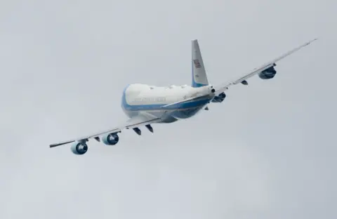 Getty Images A plane banking against a grey sky