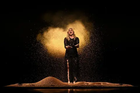 Getty Images Louane is surrounded by sand as she performs at Eurovision