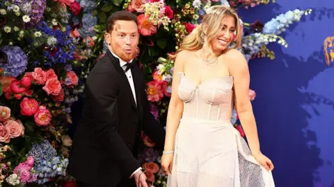 Getty Images Joe Swash and Stacey Solomon show off her wedding dress on the red carpet