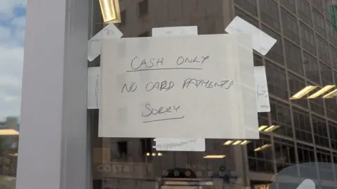 BBC A sign on a Co-op shop reading "Cash only, no card payments, sorry"