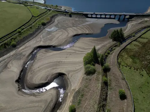 Getty Images An aerial photo shows the bed of Woodhead Reservoir is partially revealed by a falling water level, near Glossop, northern England on May 9, 2025.