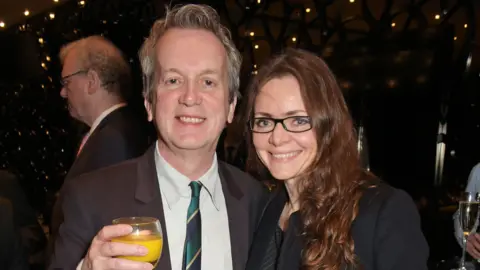 Getty Images Frank Skinner and Cath Mason at an event in smart clothes