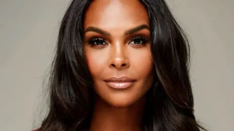 Samantha Mumba A close shot of a woman with brown curly hair