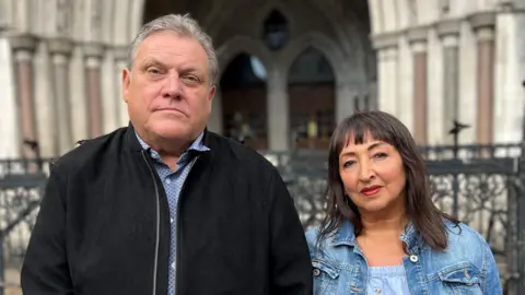 BBC Brendan and Marion Chesterton outside the Royal Courts of Justice, hand in hand