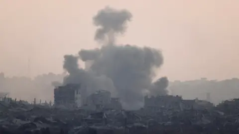 Reuters Smoke rises from Gaza after an explosion, as seen from Israel (29 May 2025).