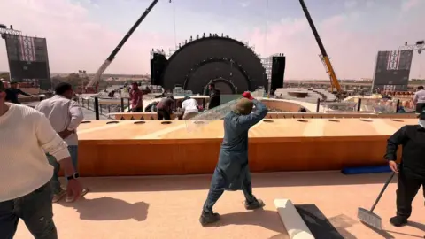 NurPhoto/Getty Migrant workers at a construction site near Riyadh, Saudi Arabia