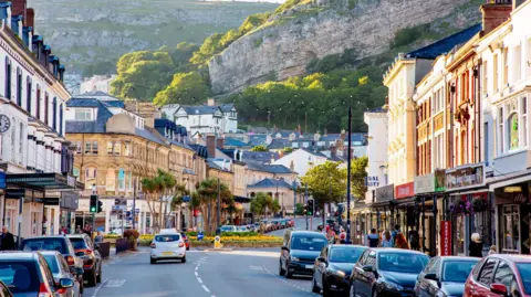 Getty Images A street in Llandudno, with cars along the street