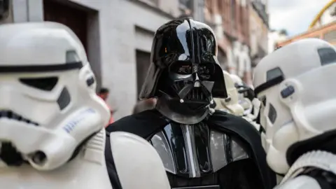 Getty Images Picture of star wars villain Darth Vader with white Stormtroopers