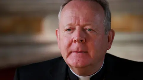 BBC Archbishop Eamon Martin, with short grey hair, dressed in black and pictured from the shoulders up.