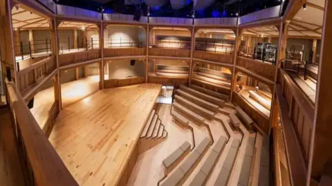 Andrew Brooks overhead view of wooden stage with seats in front and an octagonal gallery around it
