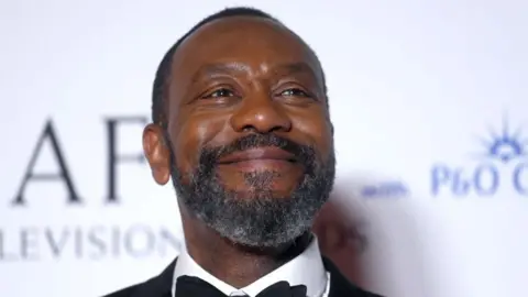 Getty Images Sir Lenny Henry smiling as he looks slightly off camera. He is wearing a dinner suit with a dicky bow.