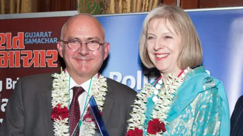 Alamy Andrew Norfolk, pictured with Theresa May in 2013, receiving the Reporter of the Year at the Political and Public Life Awards