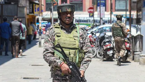 Getty Images An Indian paramilitary soldier stands guard along a road in Srinagar, Jammu and Kashmir, on April 30, 2025.