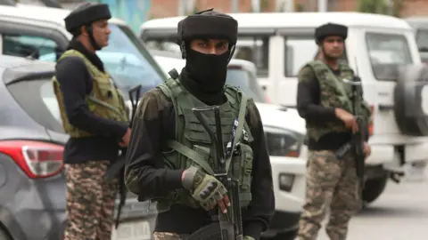 BBC Three Indian paramilitary soldiers stand guard in Srinagar, in Indian-administered Kashmir on 12 May 2025 following a ceasefire agreement on 10 May, after days of military escalation.